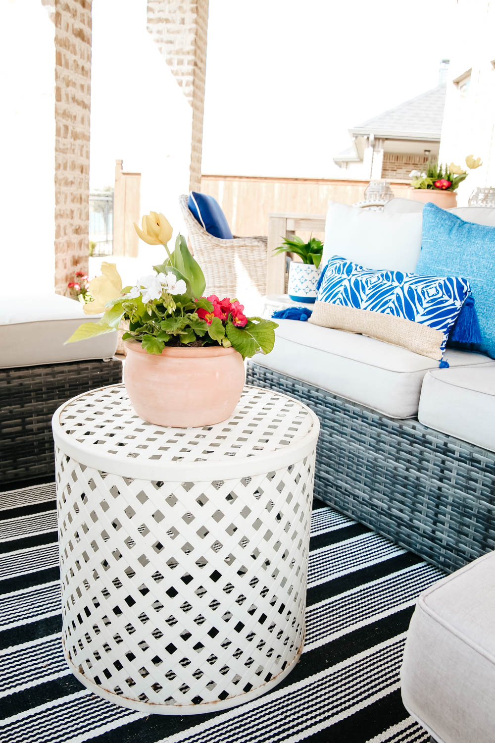 terra cotta pot, white garden stool, sprig patio decor ideas. #ABlissfulNest #patio #outdoor #backyard