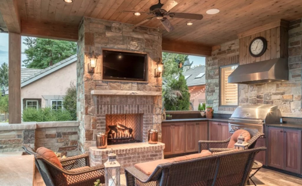 outdoor bar ideas showcased next to a stone fireplace