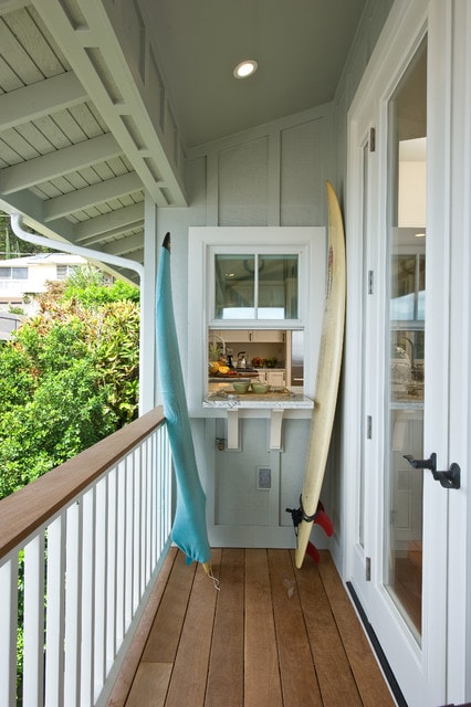 Narrow patio with open window and countertop serving as a bar