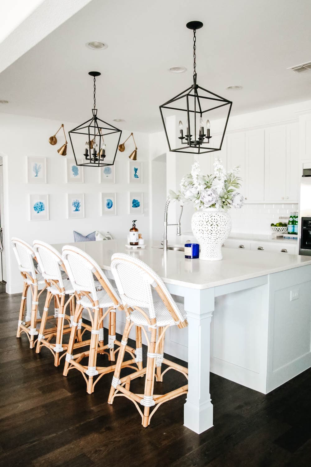 White kitchen with blue painted island. Rattan bistro chairs, black lanterns, carrara quartz counters. #ABlissfulNest #whitekitchen #springhometour