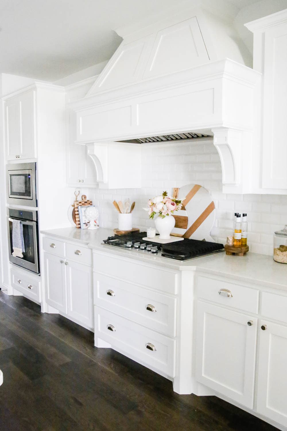 White kitchen with marble and wood cutting boards. #whitekitchen #kitcheninspo #kitchendecor #ABlissfulNest