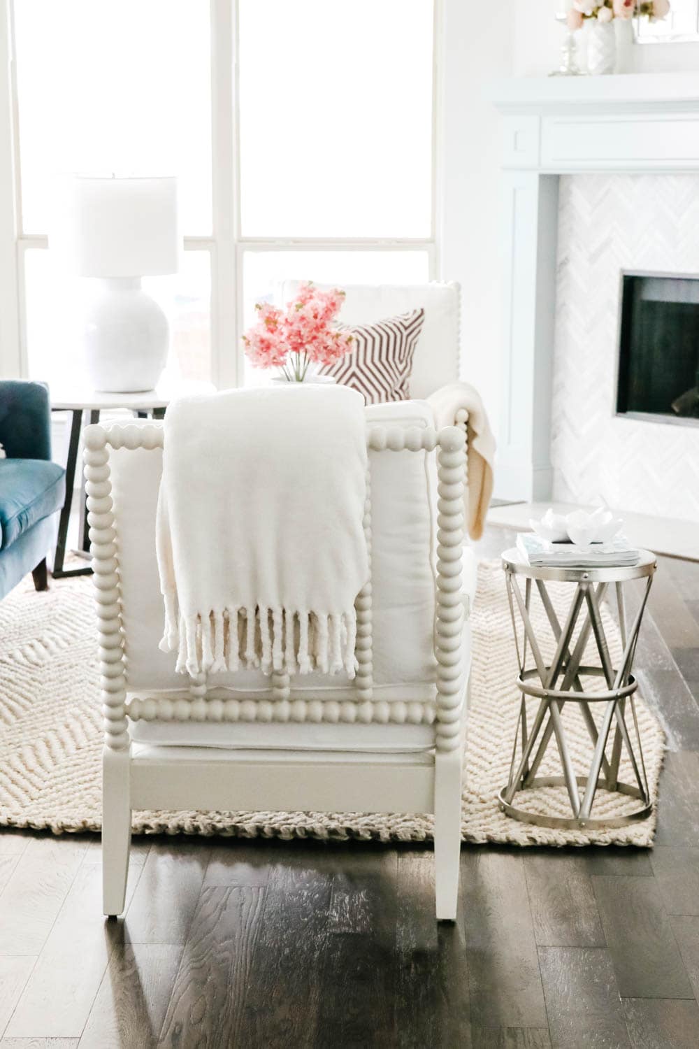 White spindle chair in coastal style living room. #livingroom #livingroominspo #hometour #ABlissfulNest