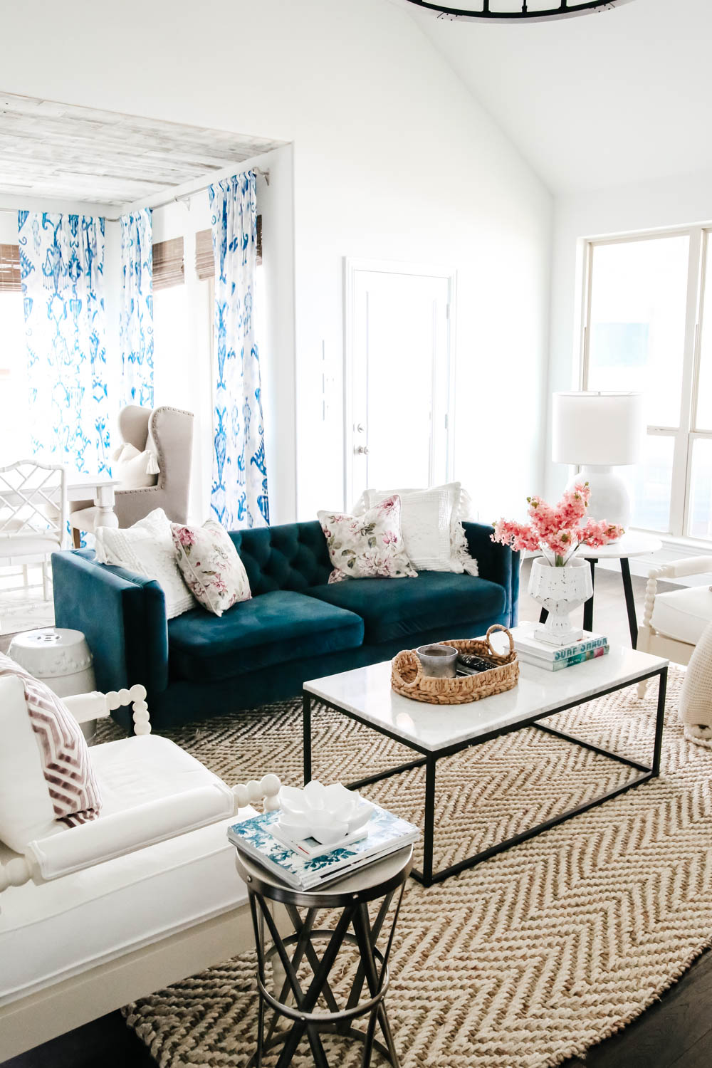 Navy blue sofa, marble and iron coffee table, white painted walls, blue and white decor accents with pops of lavender. #livingroominspo #springdecor #homedecor #ABlissfulNest