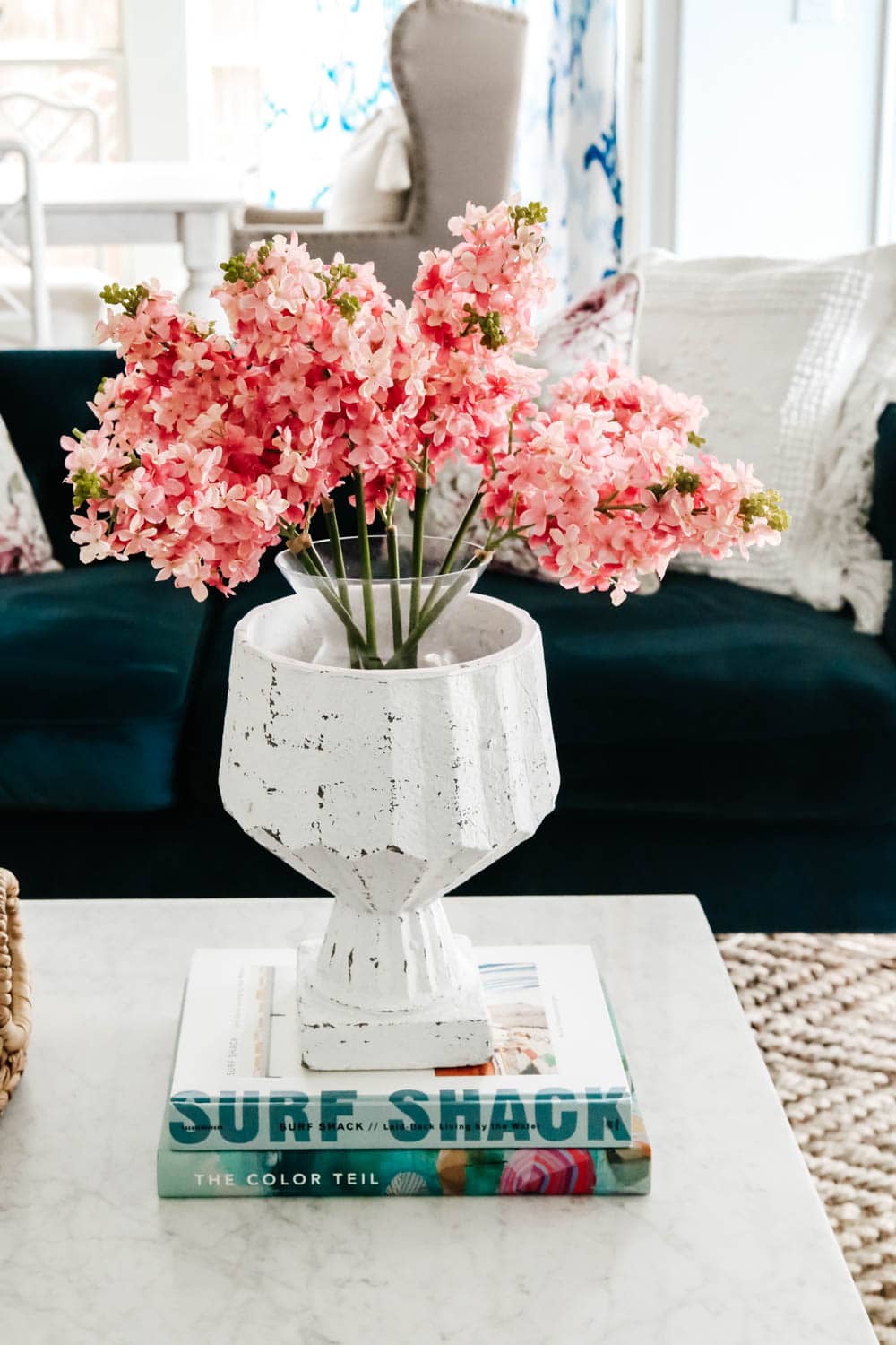 Spring flowers, home decor coffee table books, navy sofa, living room inspiration. #livingroominspo #hometour #fauxflorals #ABlissfulNest