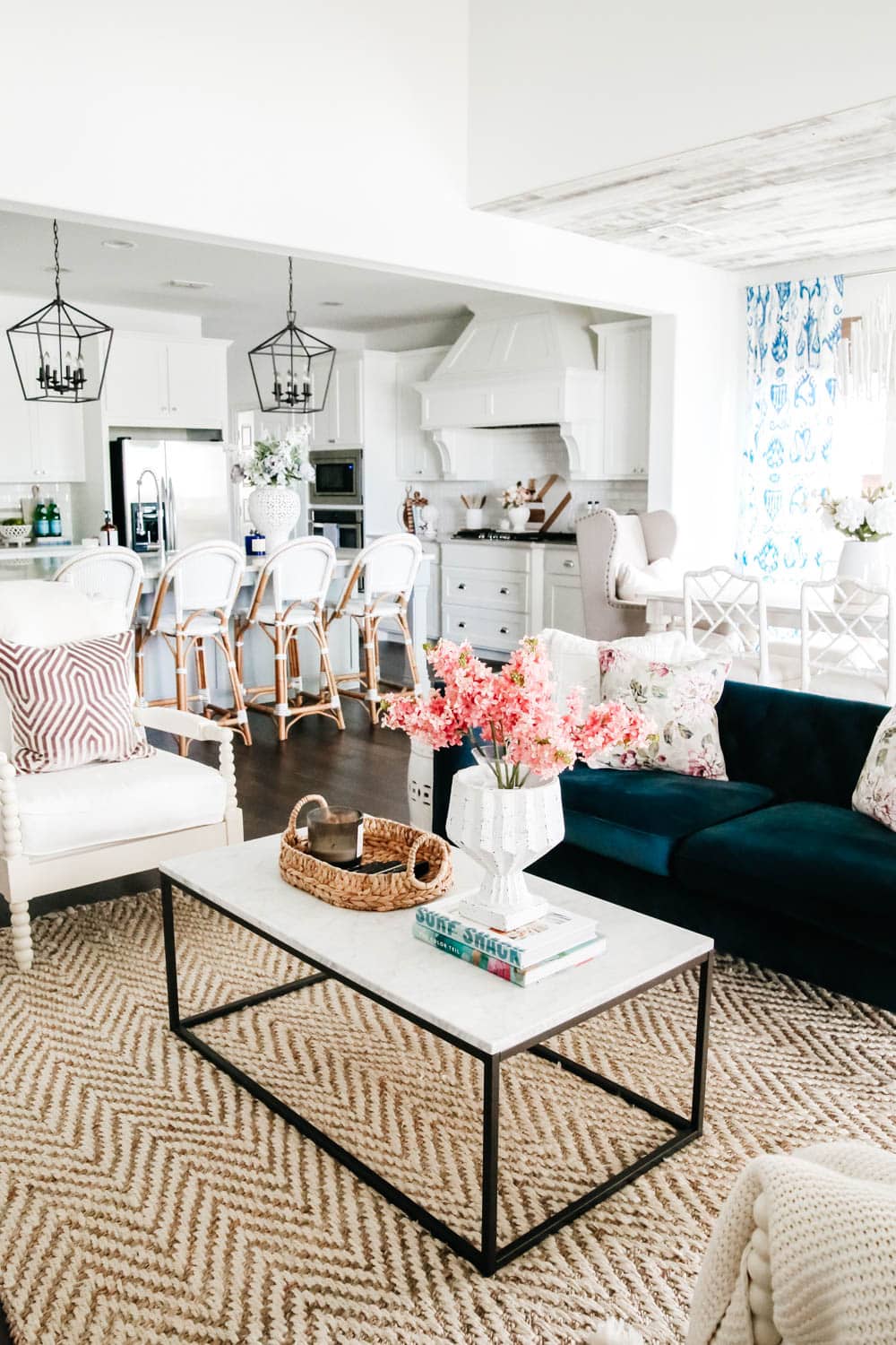 Living room with navy blue sofa and white walls. Blue and white home decor accents with pops of pink and lavender. #livingroom #livingroominspo #hometour #ABlissfulNest