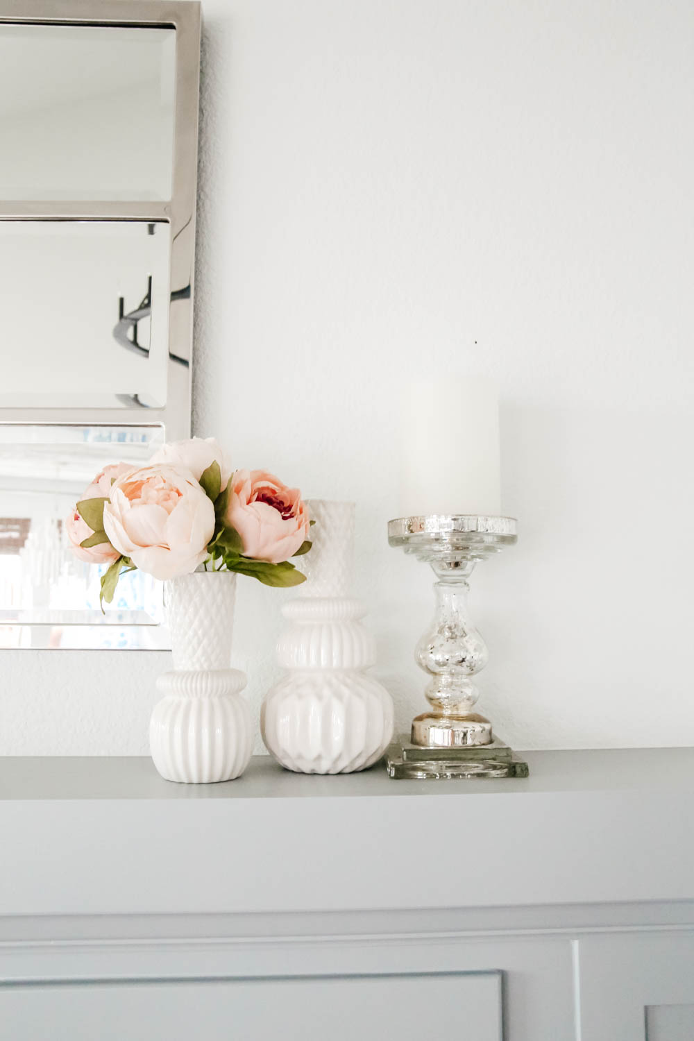 Fireplace decor details. White vases, mercury glass candlestick, peonies flowers. #livingroominspo #hometour #springdecor #ABlissfulNest