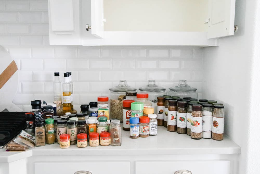 A before and after on how to purge a spice cabinet and the best organization products to use. #spicecabinet #kitchen #organization #ABlissfulNest