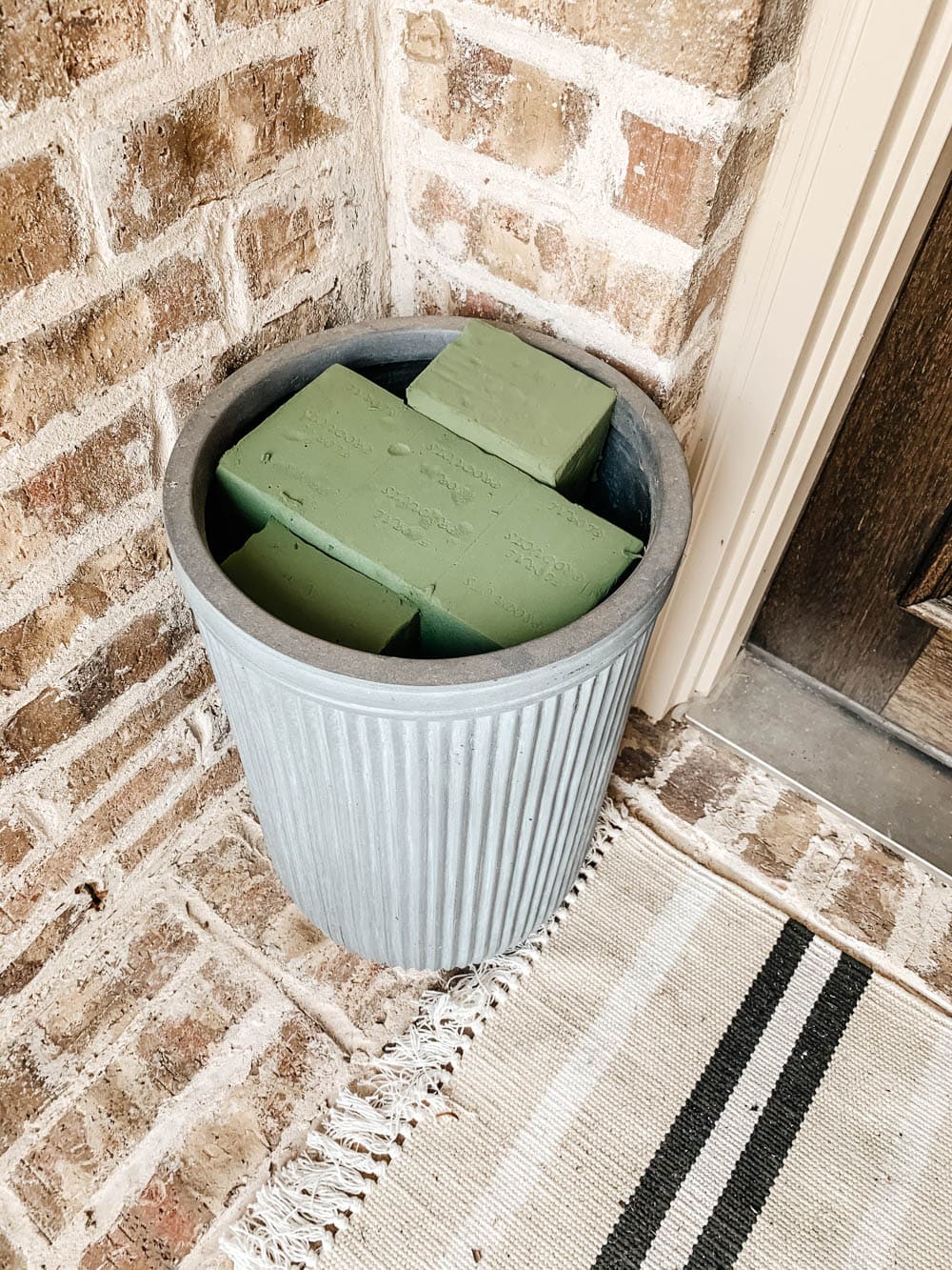 Foam blocks in the top of the planter help keep the faux plants in place