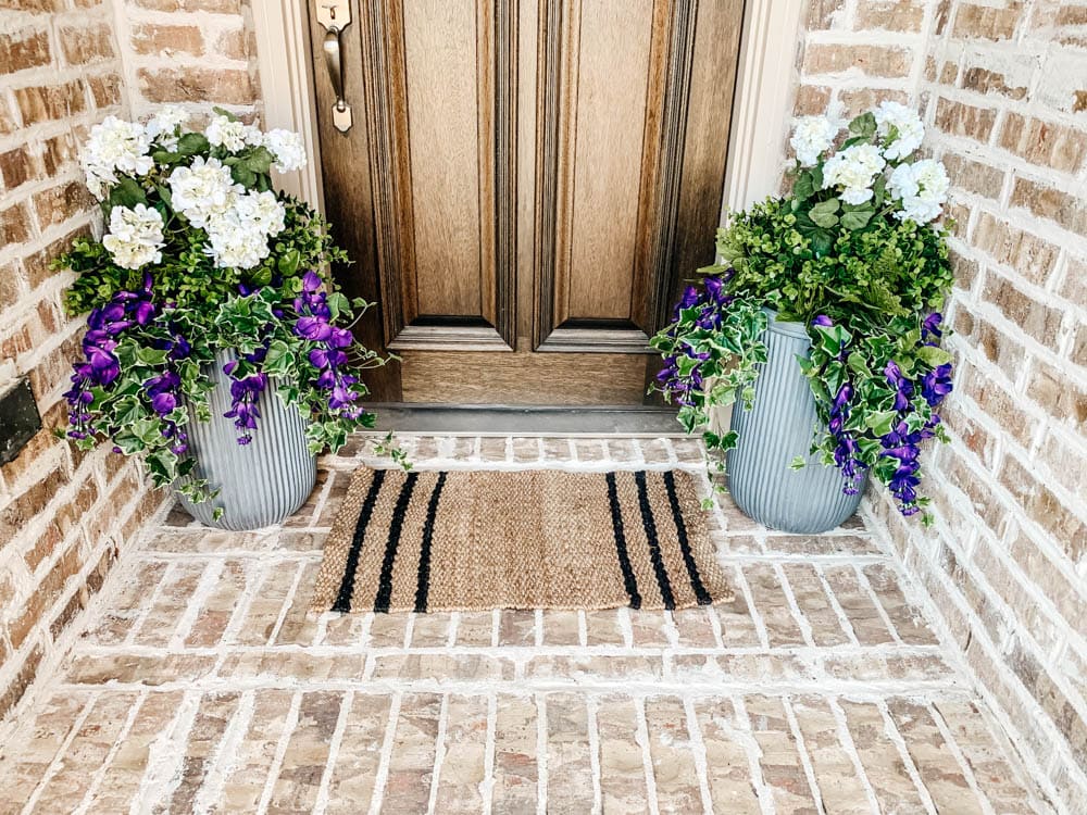 Close up of planters finished with faux flowers and plants. 