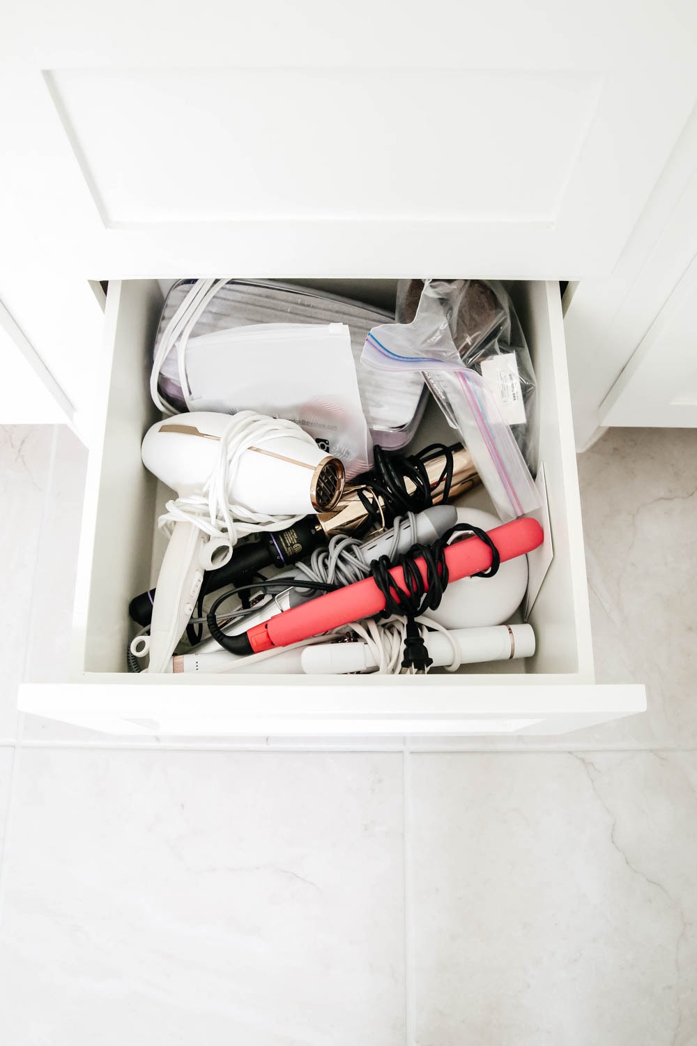 An easy hack to organize your bathroom cabinets and make them easy to clean + maintain to keep the clutter away.