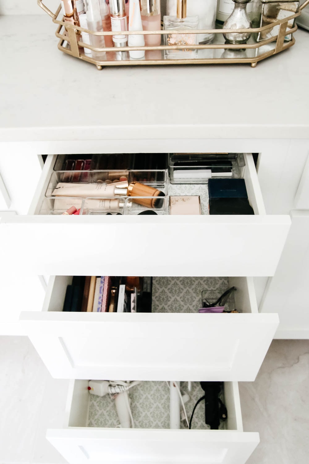 An easy hack to organize your bathroom cabinets and make them easy to clean + maintain to keep the clutter away.