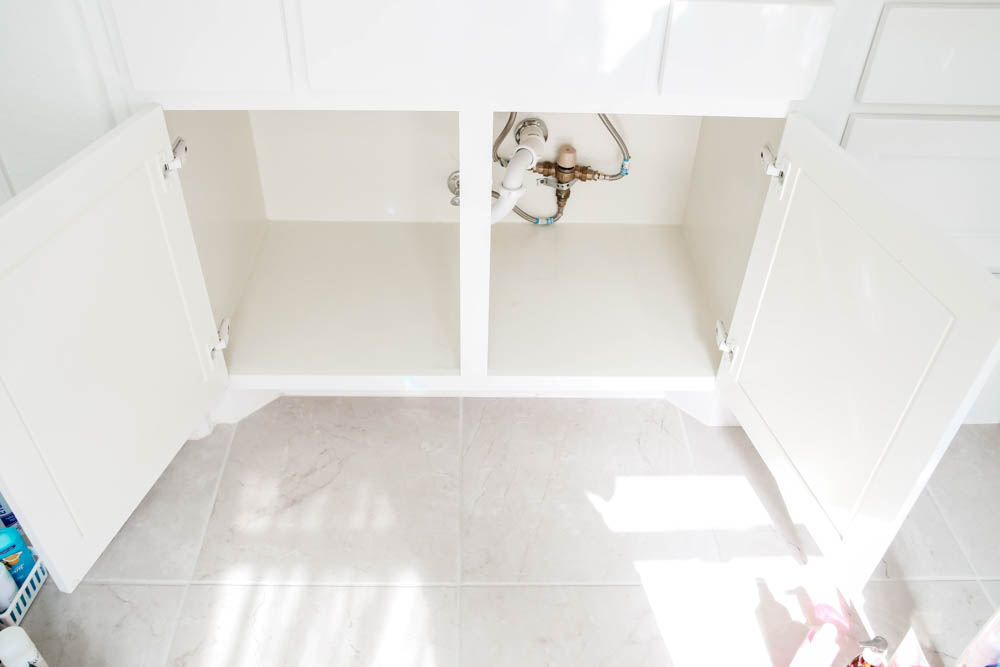 An easy hack to organize your bathroom cabinets and make them easy to clean + maintain to keep the clutter away.