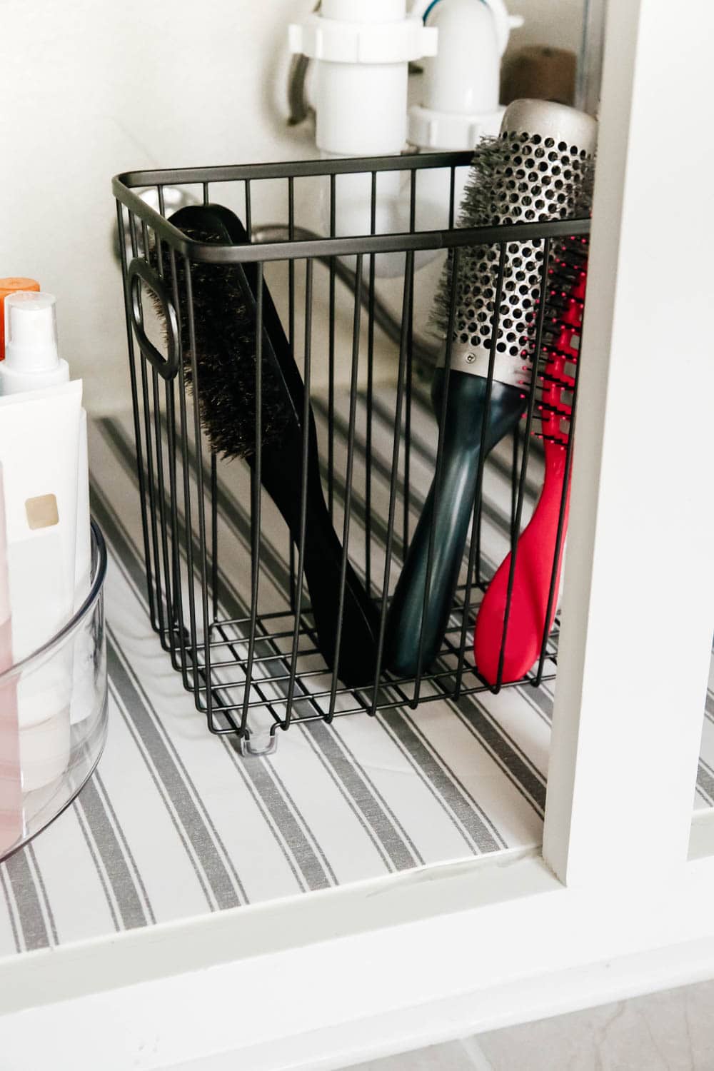An easy hack to organize your bathroom cabinets and make them easy to clean + maintain to keep the clutter away.