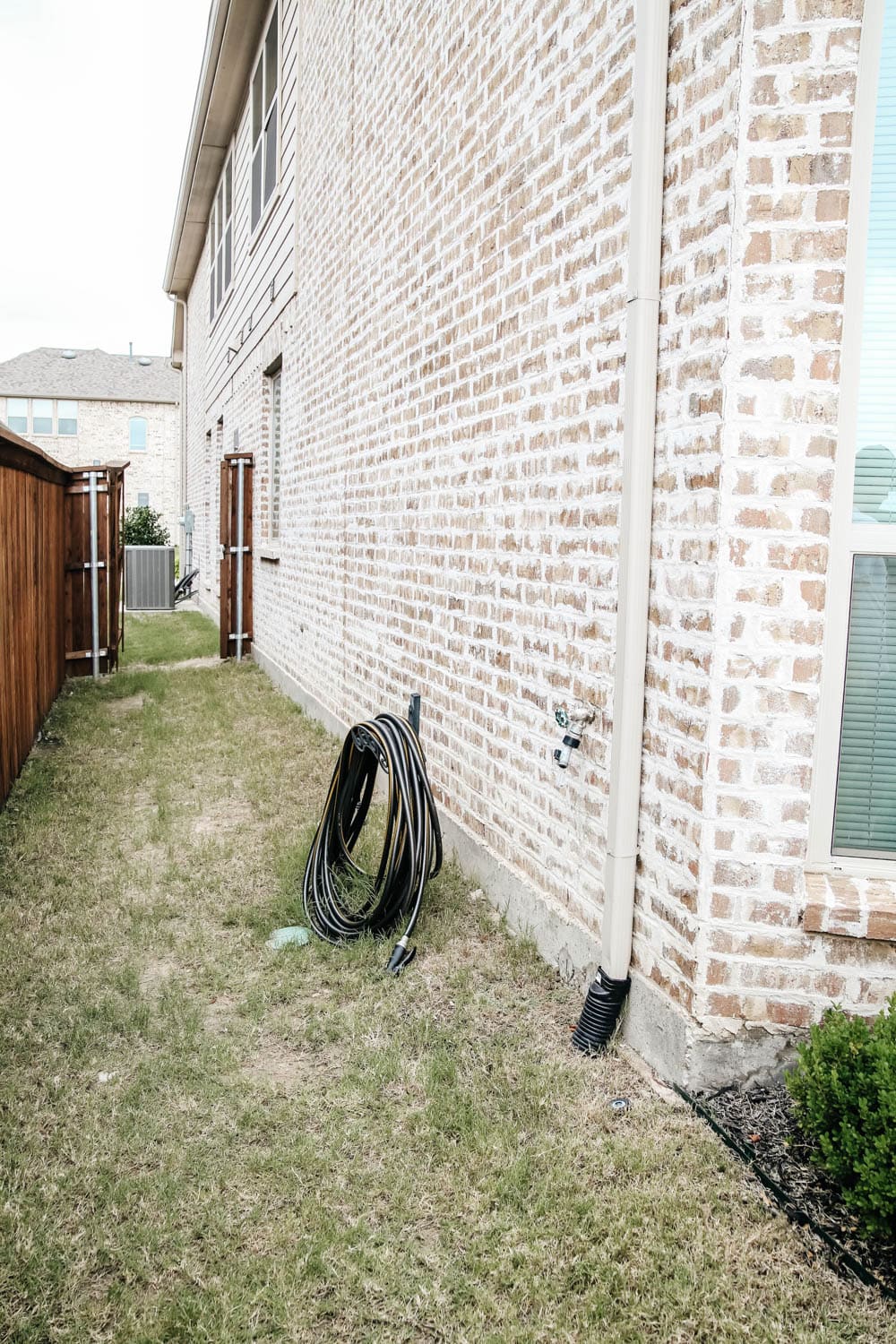 Install a rain barrel system for your home and save money and conserve your water supply. Simple step-by-step tutorial for installing a rain barrel. #ABlissfulNest