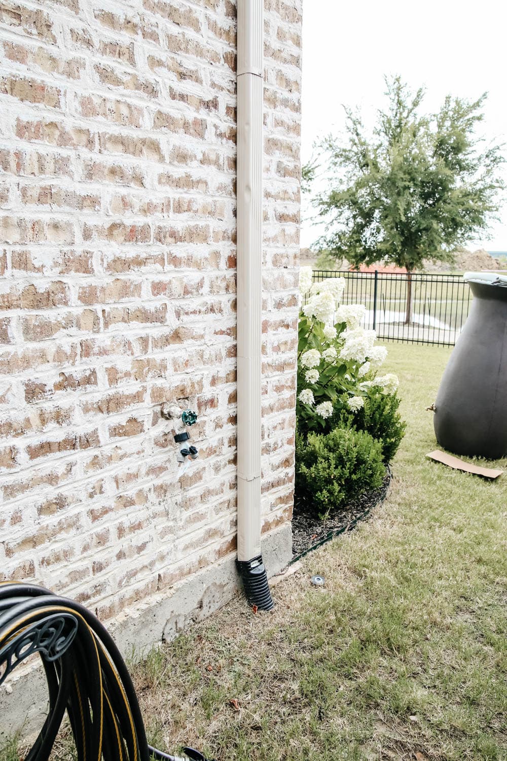 Install a rain barrel system for your home and save money and conserve your water supply. Simple step-by-step tutorial for installing a rain barrel. #ABlissfulNest