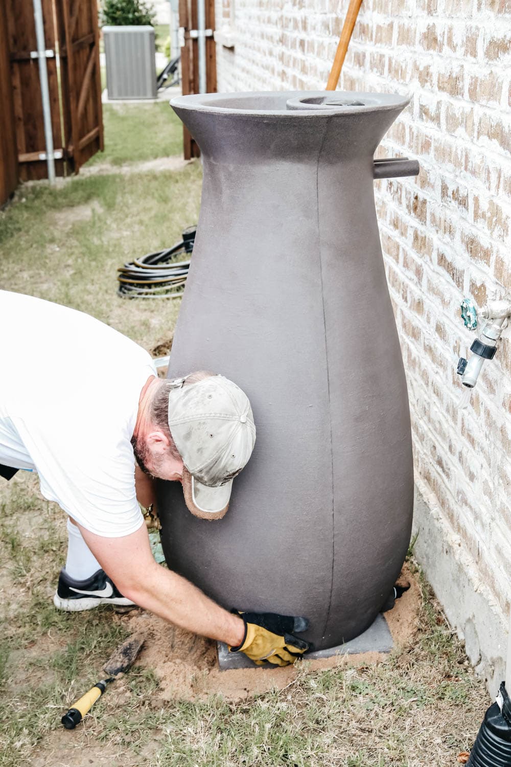 Install a rain barrel system for your home and save money and conserve your water supply. Simple step-by-step tutorial for installing a rain barrel. #ABlissfulNest