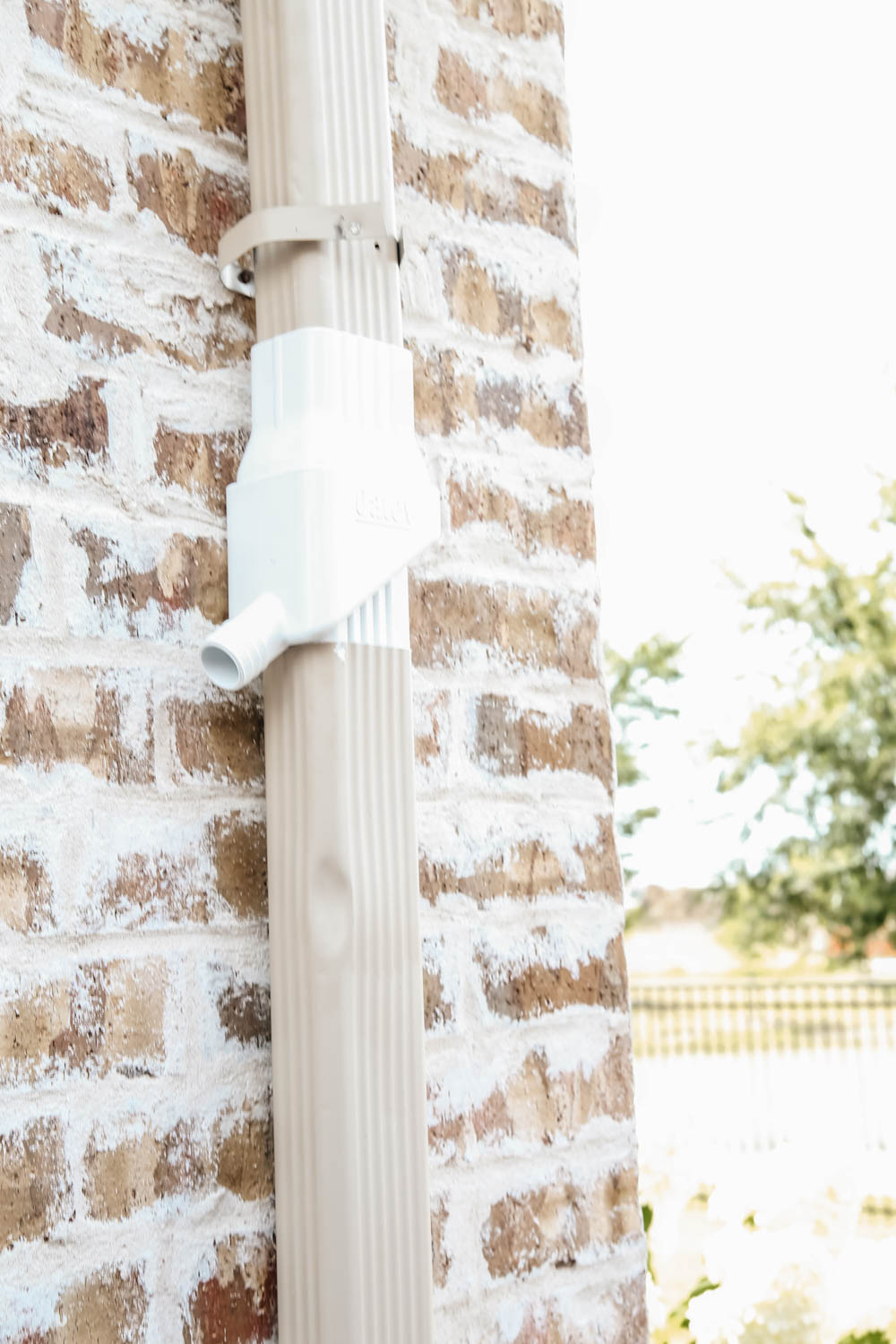 Install a rain barrel system for your home and save money and conserve your water supply. Simple step-by-step tutorial for installing a rain barrel. #ABlissfulNest