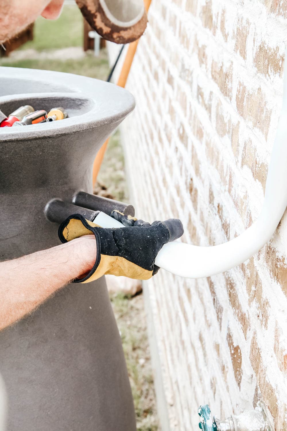 Install a rain barrel system for your home and save money and conserve your water supply. Simple step-by-step tutorial for installing a rain barrel. #ABlissfulNest