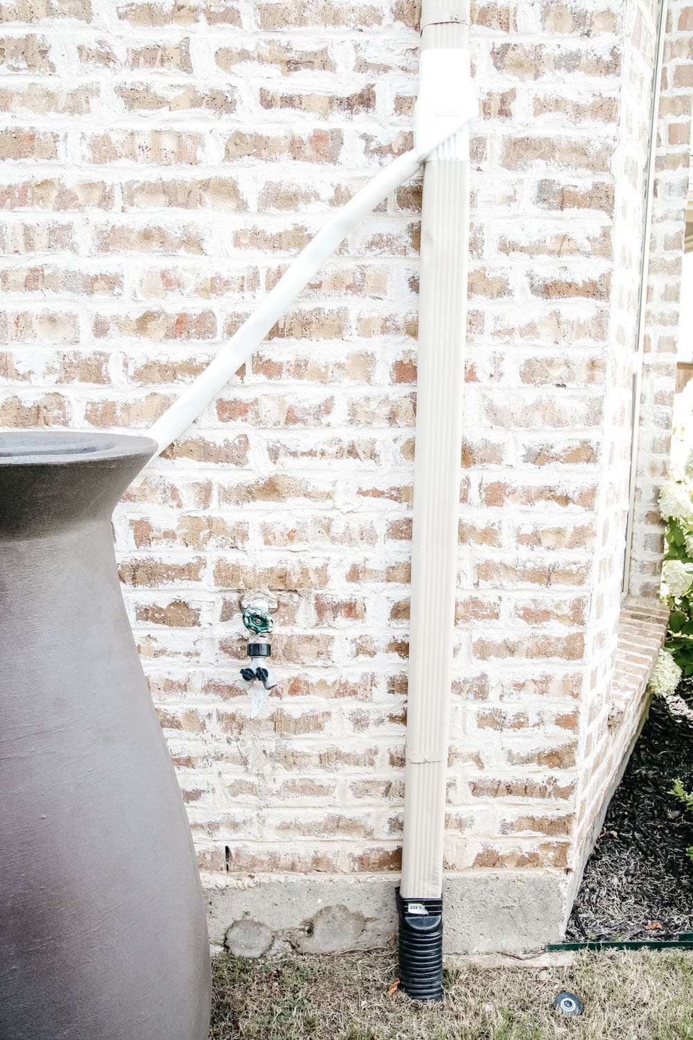 Install a rain barrel system for your home and save money and conserve your water supply. Simple step-by-step tutorial for installing a rain barrel. #ABlissfulNest