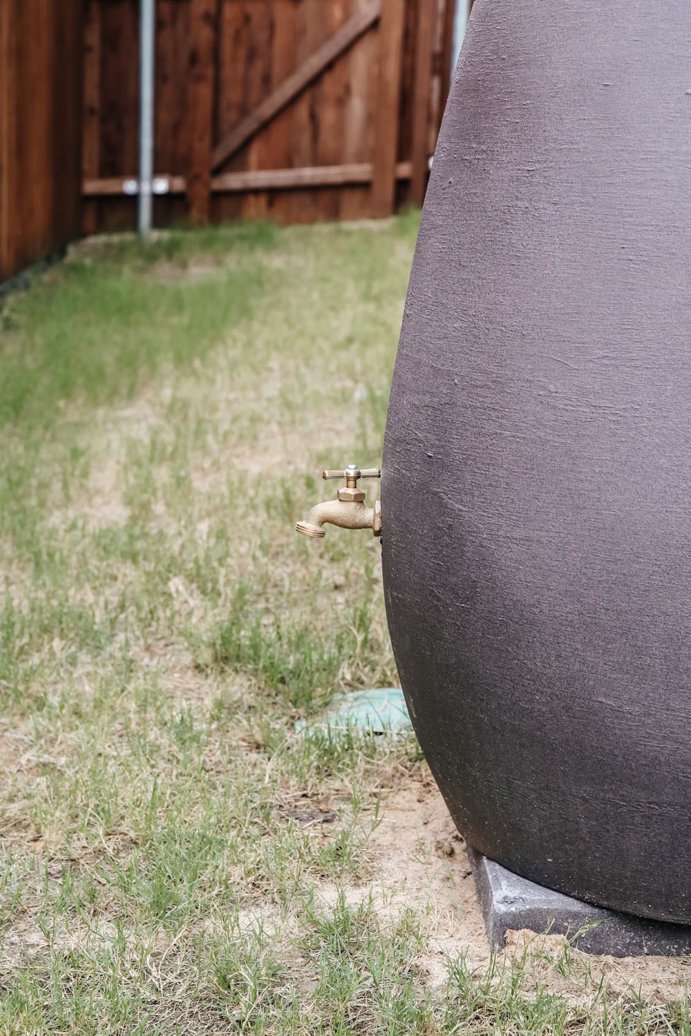 Install a rain barrel system for your home and save money and conserve your water supply. Simple step-by-step tutorial for installing a rain barrel. #ABlissfulNest