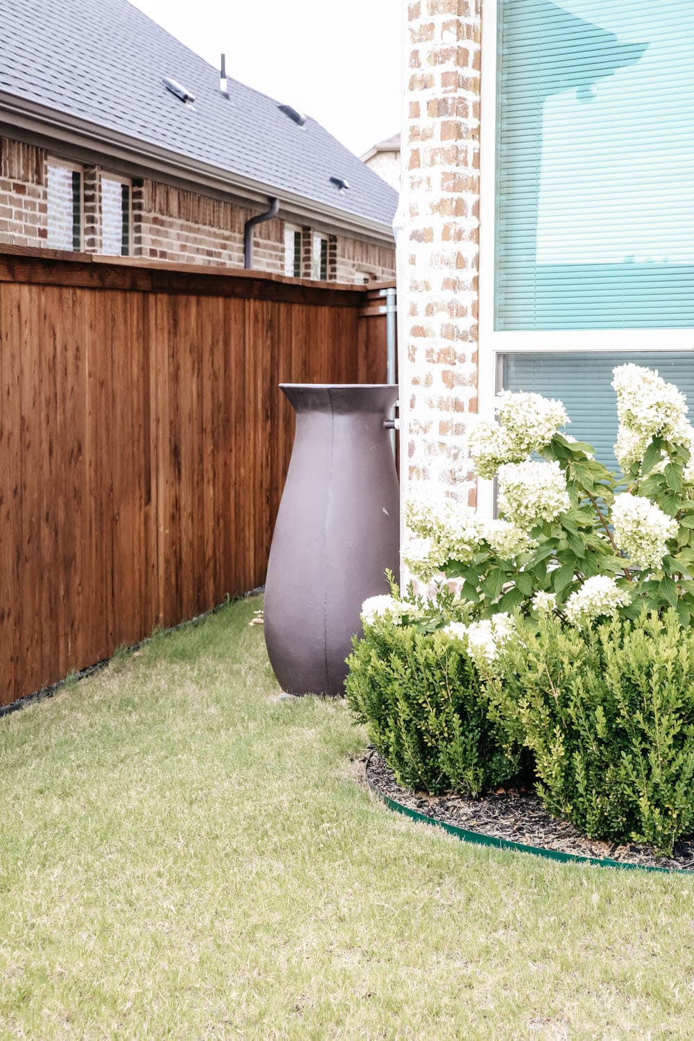 Install a rain barrel system for your home and save money and conserve your water supply. Simple step-by-step tutorial for installing a rain barrel. #ABlissfulNest