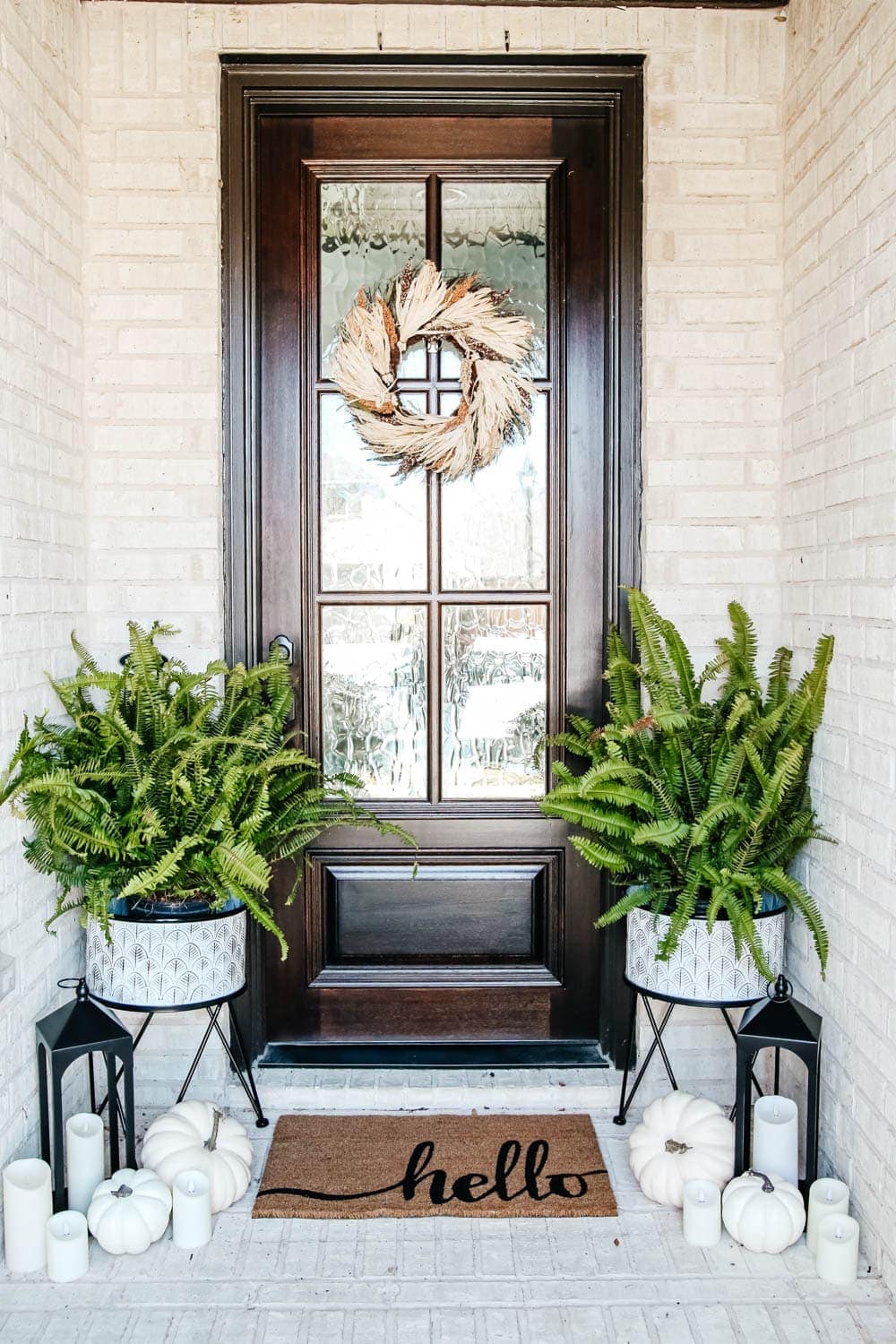 This porch has more neutral fall decor with white pumpkins and a wheat wreath details. #ABlissfulNest #falldecor #fallporch