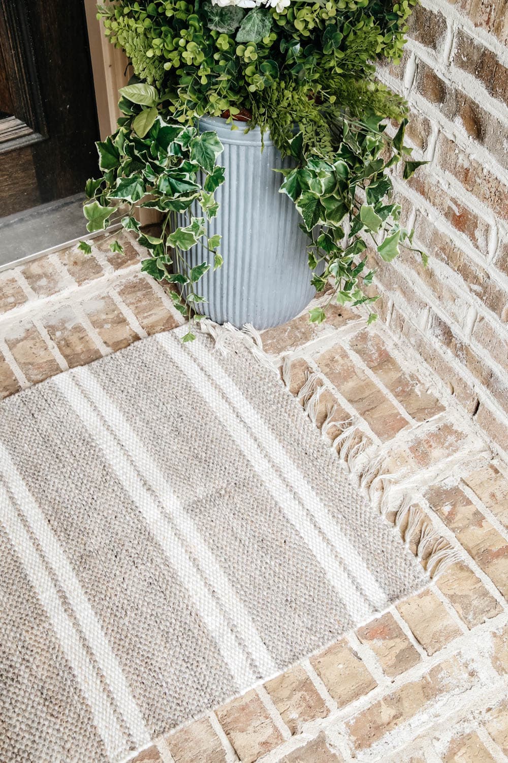 Layer your doormat with a patterned area rug for some contrast. #ABlissfulNest #fallporch