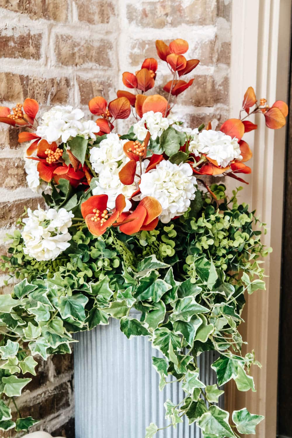 Switch out the flowers in your planters to coordinate with your fall wreath. #ABlissfulNest #fallporch