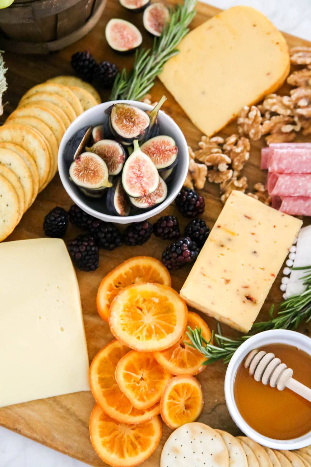 Yummy details on this fall charcuterie board with mixes of fruit, crackers, fresh rosemary and more! #ABlissfulNest #cheeseboard #fall #ad #RothCheese