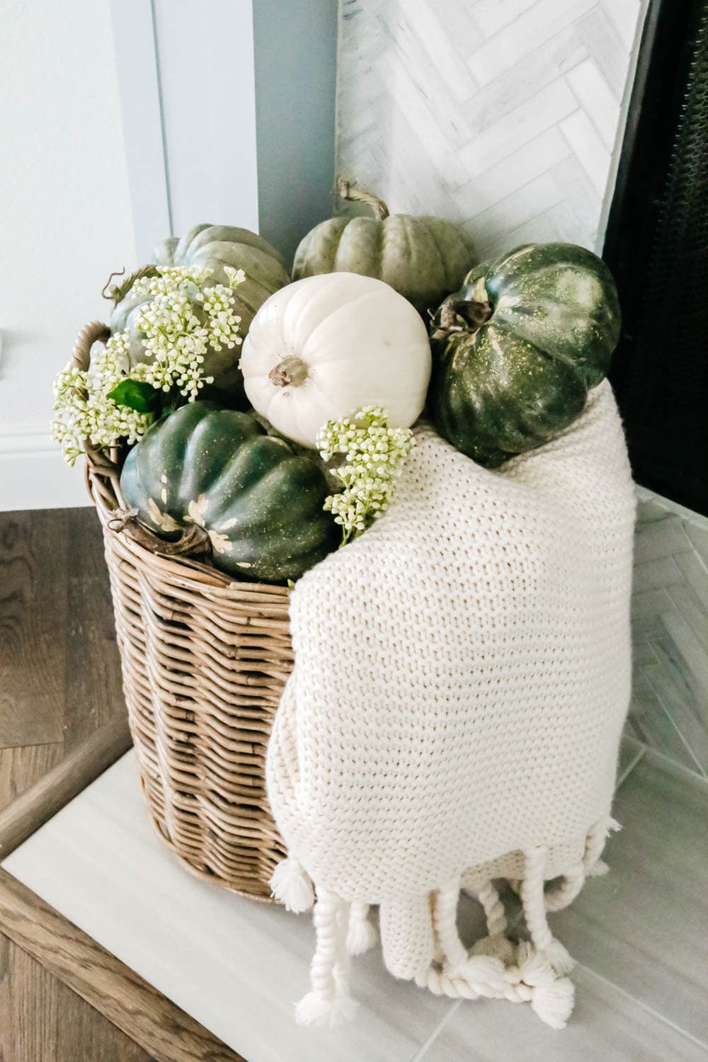 Use baskets for cozy blankets and fall decor accents next to the fireplace. #ABlissfulNest #falldecoratingideas