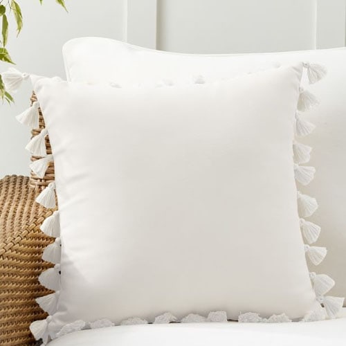 This white tassel trim throw pillow is a perfect, neutral addition to your outdoor setup this season! #ABlissfulNest