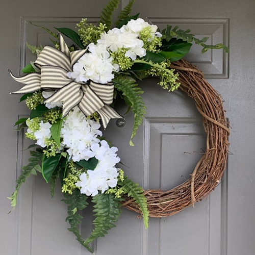 This white hydrangea wreath is a stunning addition to your front door this summer! #ABlissfulNest