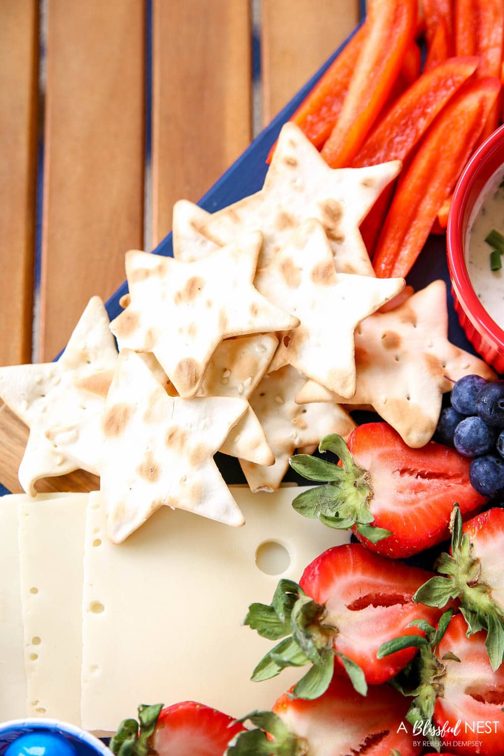 A beautiful patriotic charcuterie board with something for everyone. #ABlissfulNest #charcuterieboard #4thofjuly