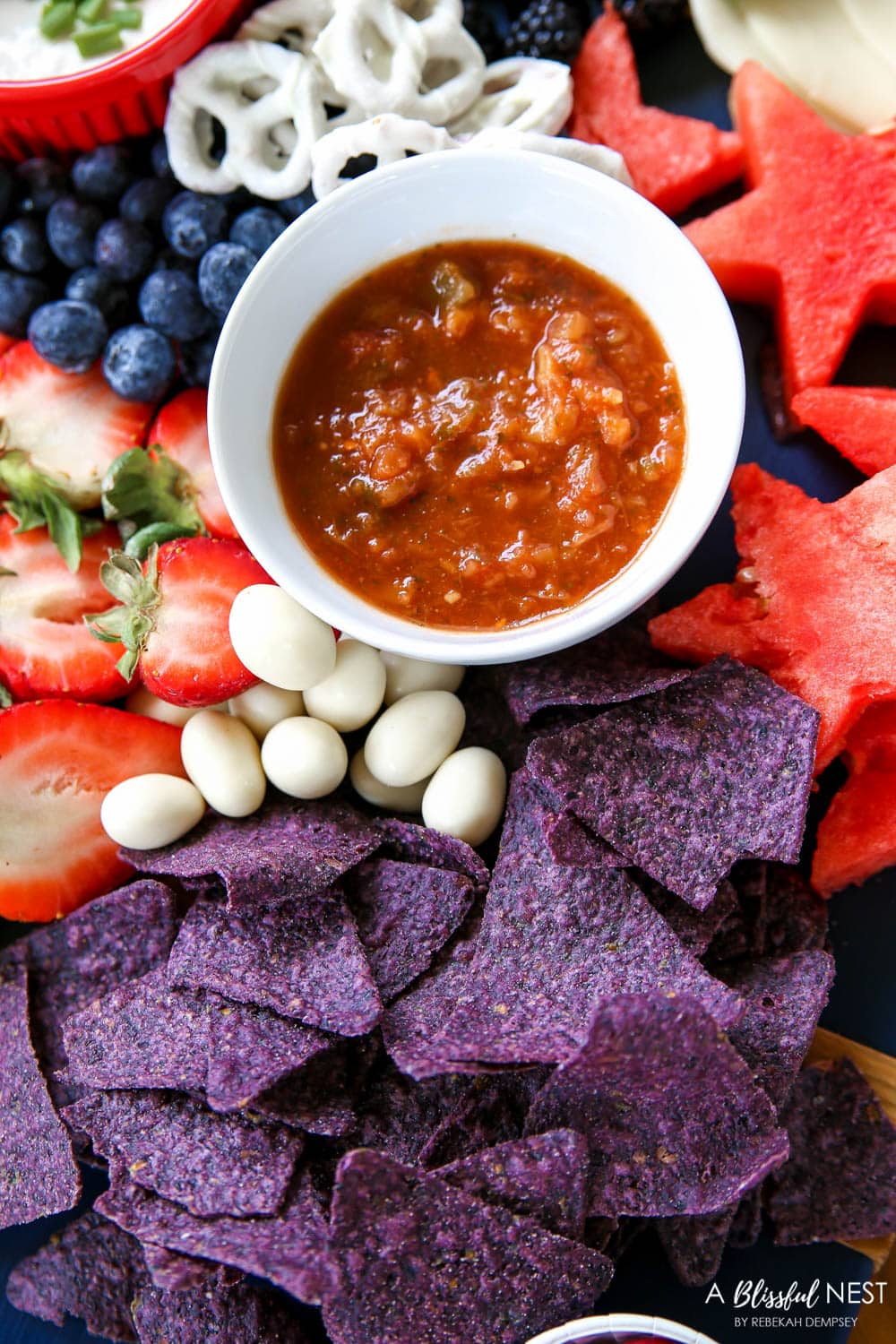 A beautiful patriotic charcuterie board with something for everyone. #ABlissfulNest #charcuterieboard #4thofjuly