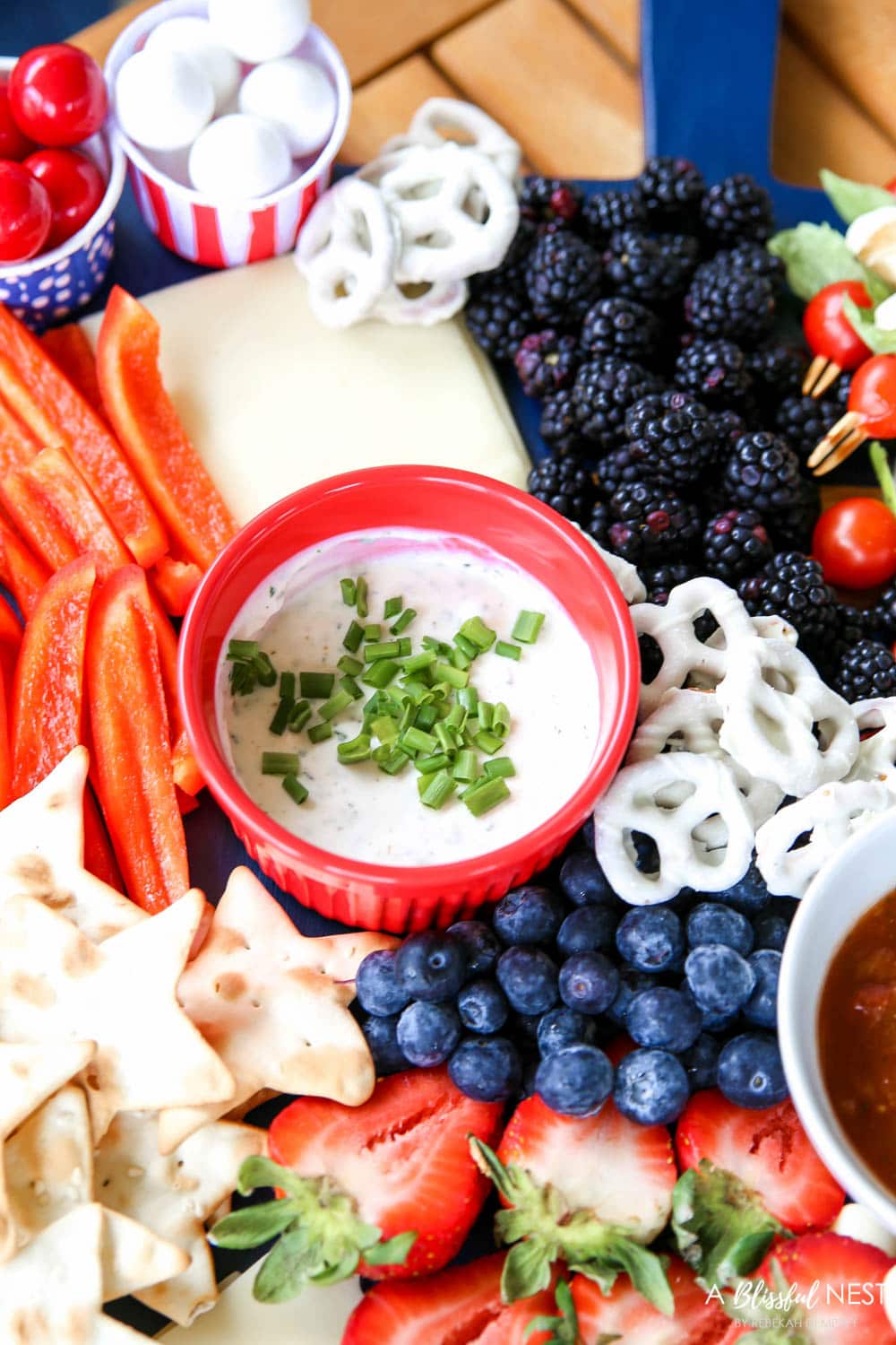 A beautiful patriotic charcuterie board with something for everyone. #ABlissfulNest #charcuterieboard #4thofjuly