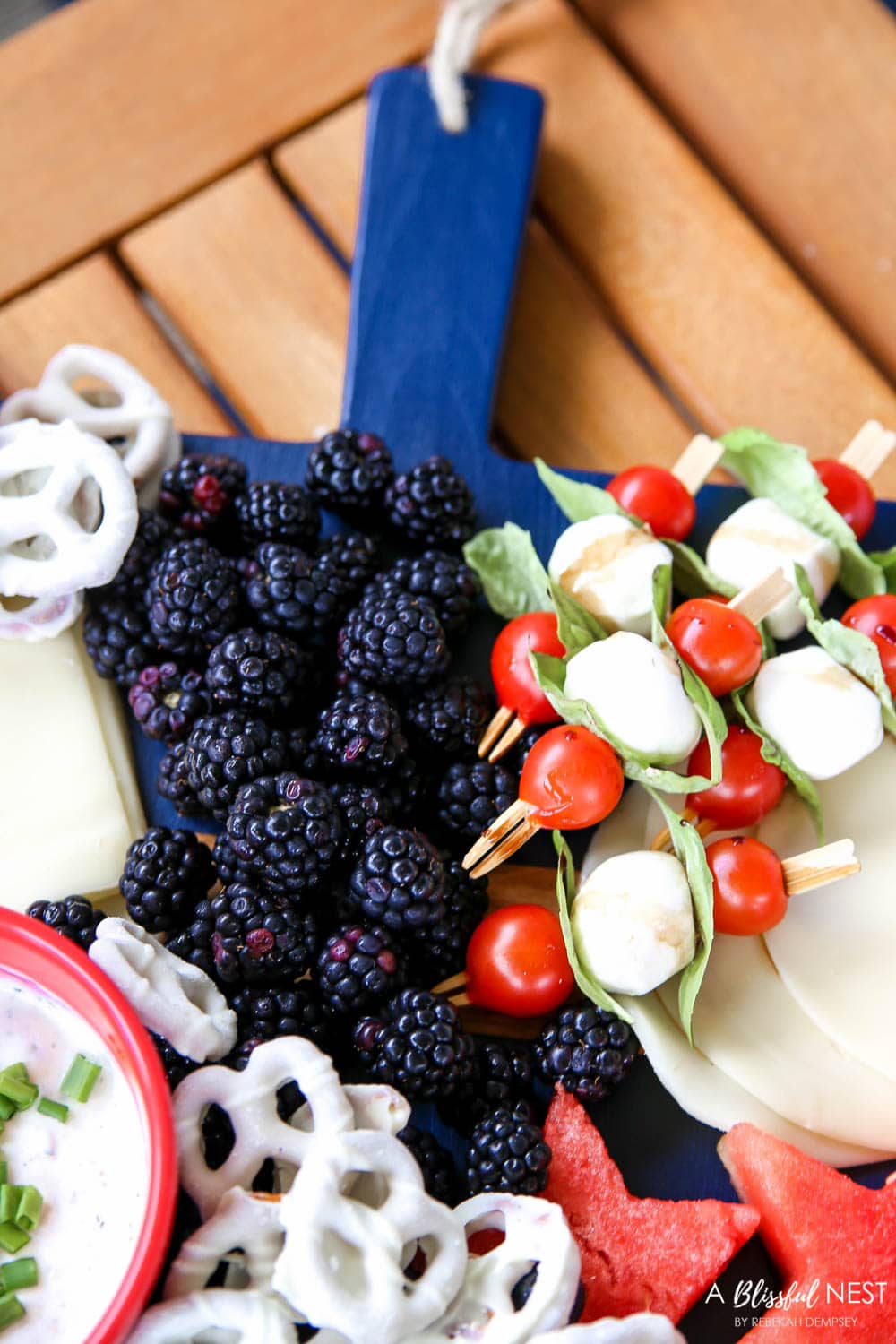 A beautiful patriotic charcuterie board with something for everyone. #ABlissfulNest #charcuterieboard #4thofjuly