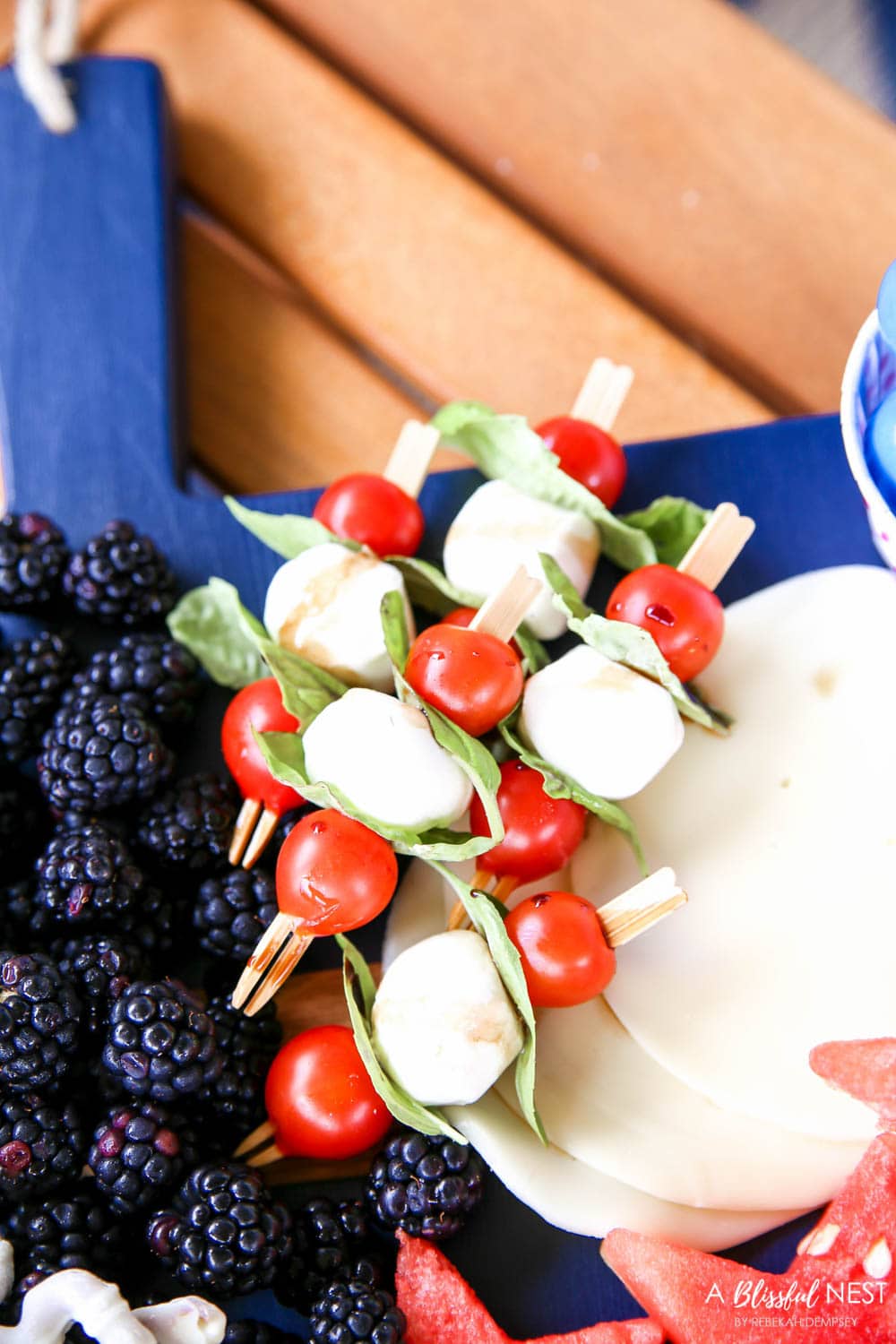 A beautiful patriotic charcuterie board with something for everyone. #ABlissfulNest #charcuterieboard #4thofjuly