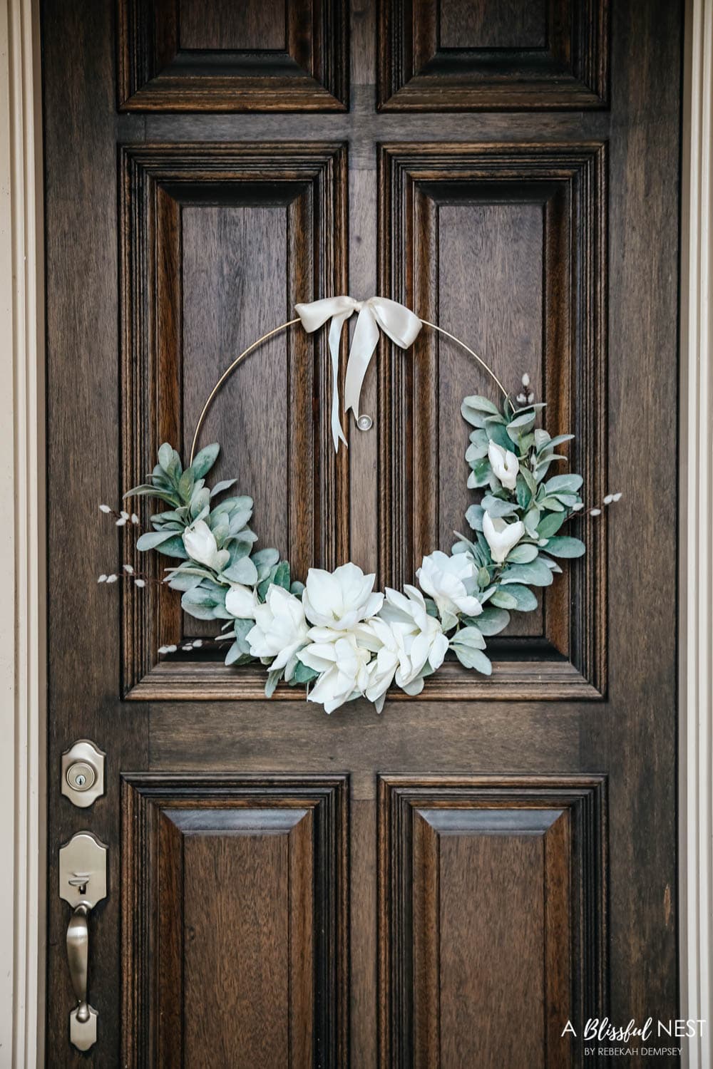 A simple fresh summer porch includes this beautiful hoop wreath, UV protected outdoor faux flowers, lanterns and more. #ABlissfulNest #summerporch #summerdecor