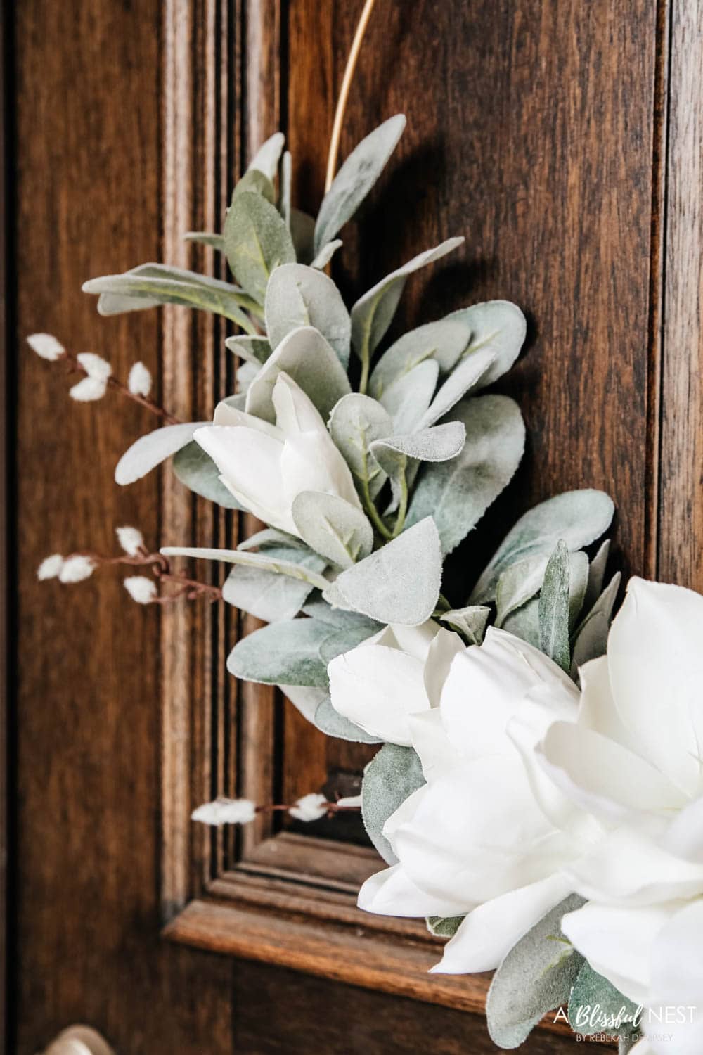 A simple fresh summer porch includes this beautiful hoop wreath, UV protected outdoor faux flowers, lanterns and more. #ABlissfulNest #summerporch #summerdecor