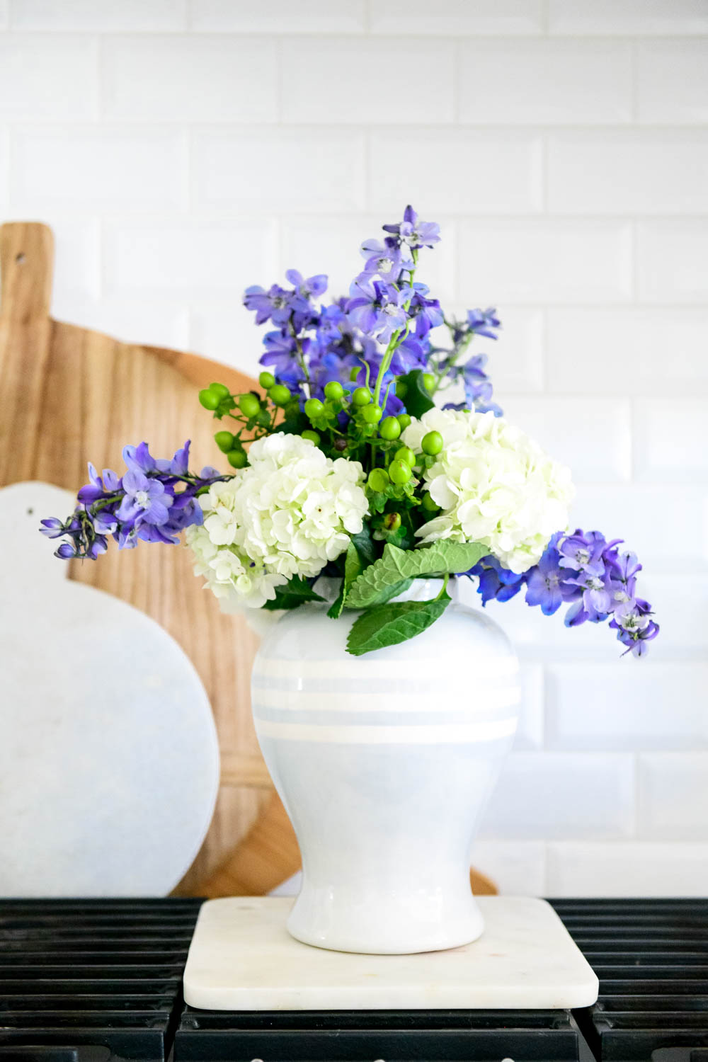 Grocery store flowers, cooktop, kitchen stove, blue and white gingham. #ABlissfulNest #whitekicthen #kitchendecor #kitchenstyle