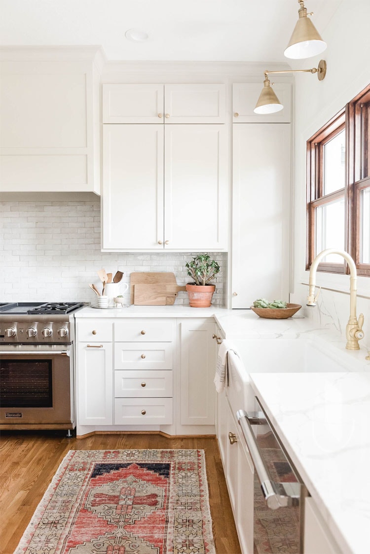 This gorgeous white and gold accented kitchen designed by High Street Homes is so beautiful!