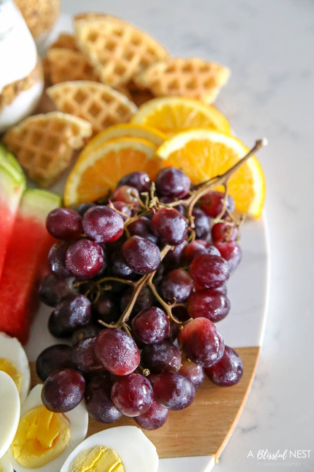 Make a brunch charcuterie board with all these breakfast items for your family on the weekends or for a girls brunch with friends. #ABlissfulNest #charcuterieboard #brunchrecipes #breakfastrecipes