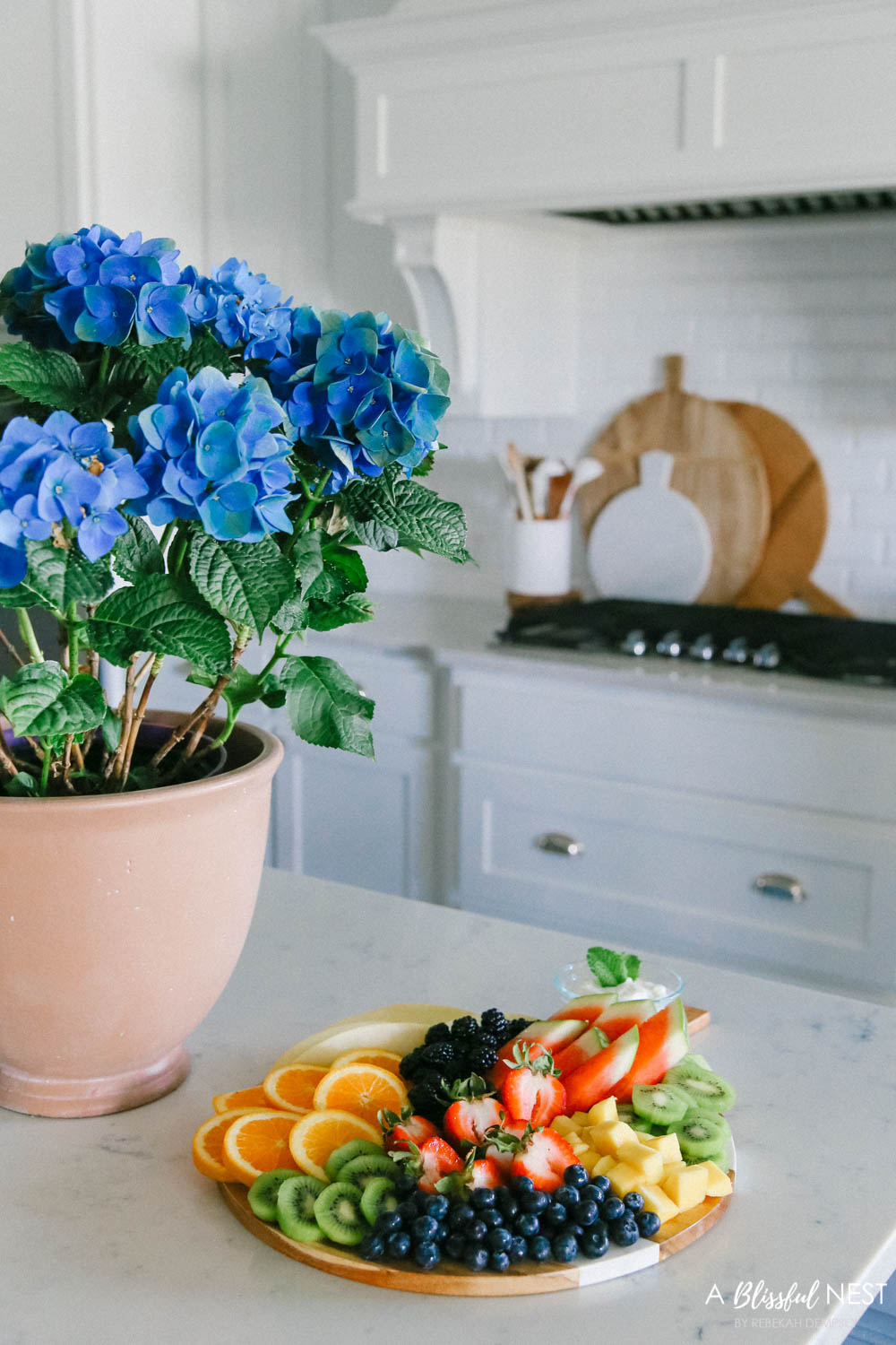 This beautiful fruit charcuterie board is so good to make on the weekends, for brunch, as an appetizer, and use all your favorite colorful fruits. #ABlissfulNest #charcuterieboard #fruitboard #fruitrecipe