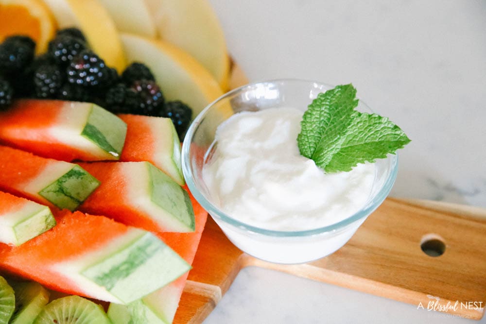 This beautiful fruit charcuterie board is so good to make on the weekends, for brunch, as an appetizer, and use all your favorite colorful fruits. #ABlissfulNest #charcuterieboard #fruitboard #fruitrecipe