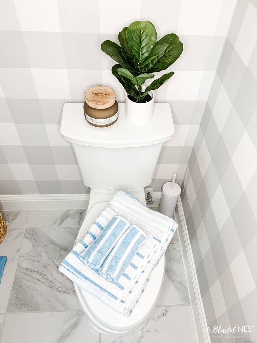 Soft blue decor accents, bathroom accessory updates, fresh candle, buffalo check wallpaper. #ABlissfulNest #WalmartHome #bathroomdesign