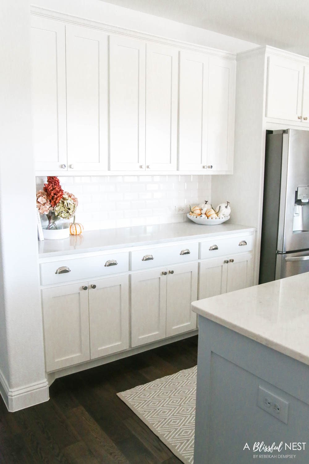 Beautiful fall decor details in this kitchen with burgundy eucalyptus leaves, delicious fall candles, Serena and Lily barstools. #ABlissfulNest #fallkitchen #falldecor #fallideas