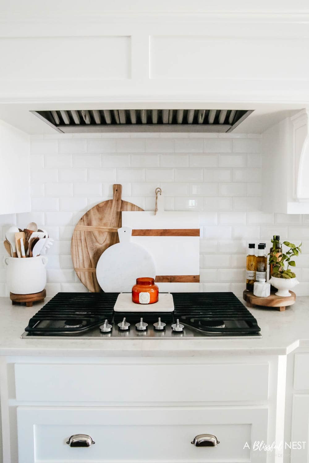 Beautiful fall decor details in this kitchen with burgundy eucalyptus leaves, delicious fall candles, Serena and Lily barstools. #ABlissfulNest #fallkitchen #falldecor #fallideas