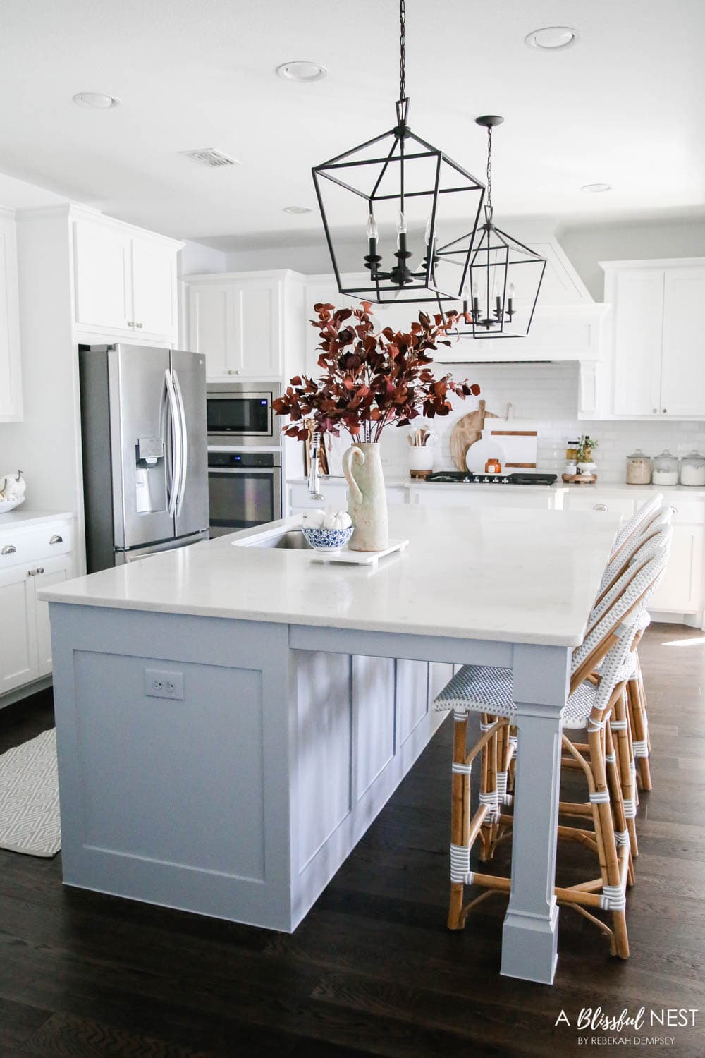 Beautiful fall decor details in this kitchen with burgundy eucalyptus leaves, delicious fall candles, Serena and Lily barstools. #ABlissfulNest #fallkitchen #falldecor #fallideas