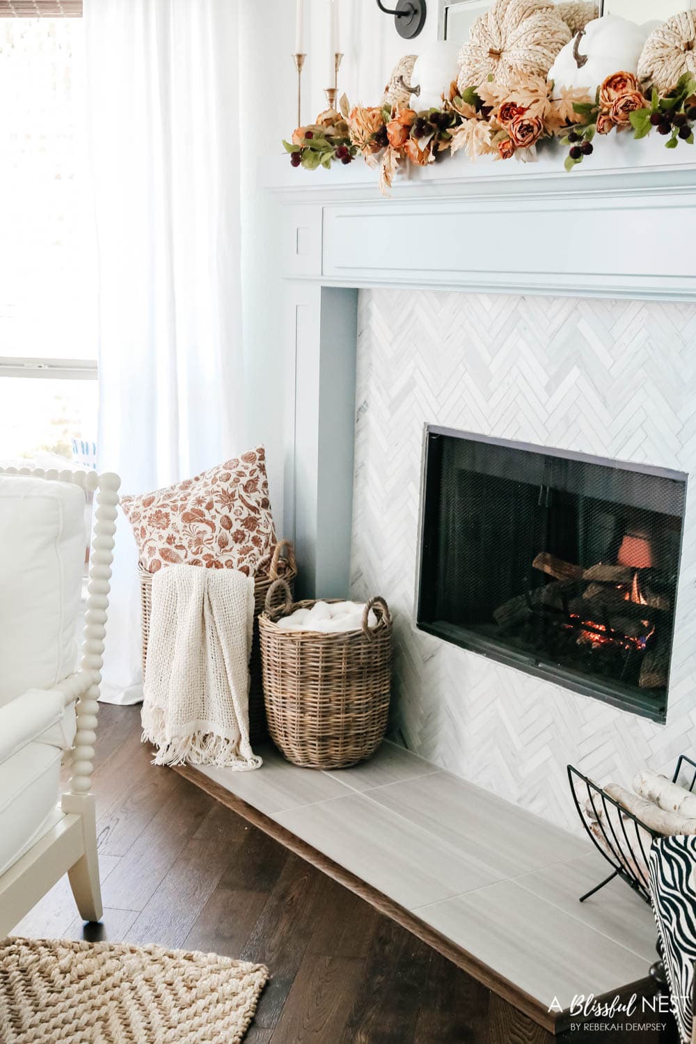 Add plush blankets to baskets next to the fireplace for accessibility in the colder weather. #ABlissfulNest #falldecor #falldecorating 