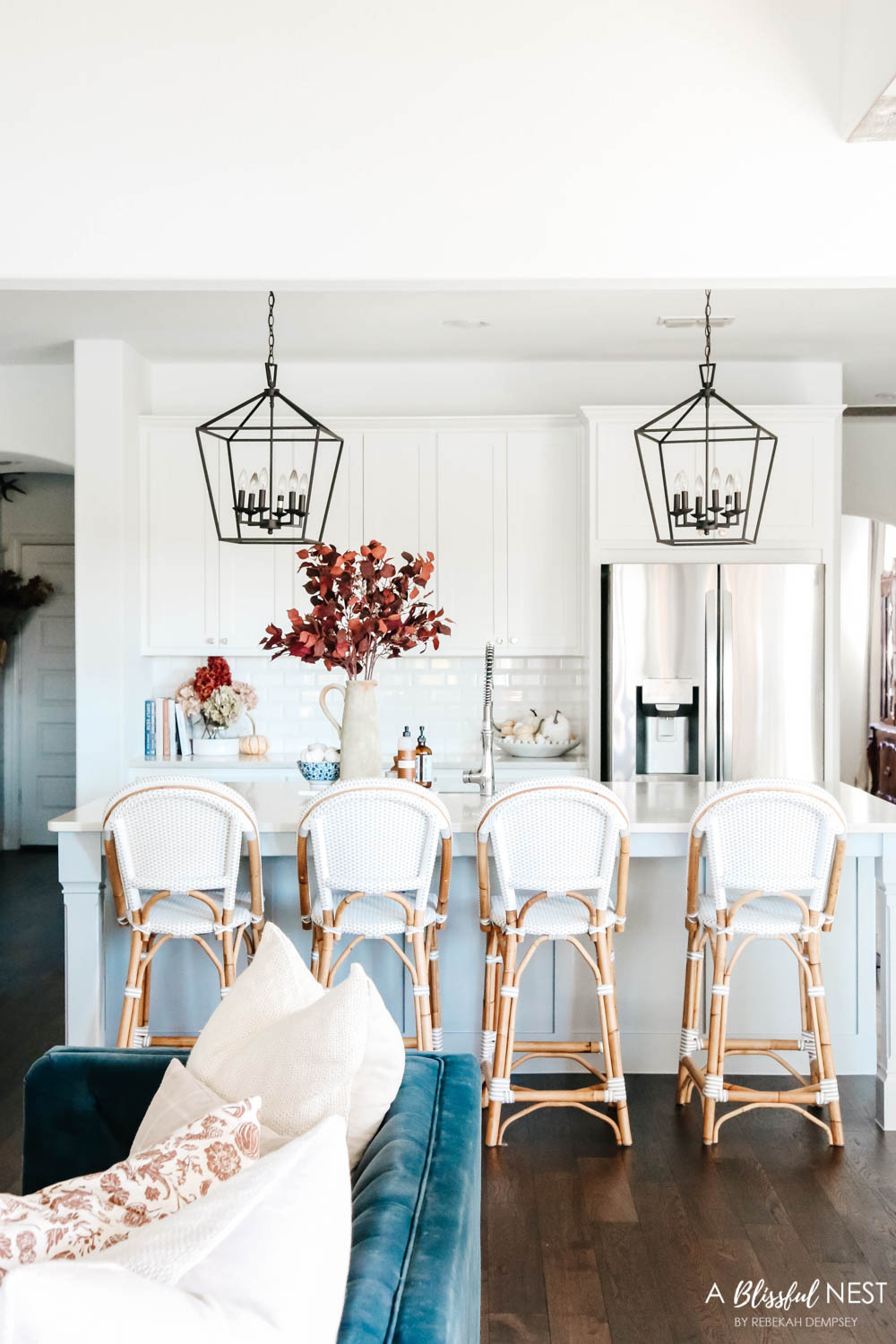 Beautiful fall decor details in this kitchen with burgundy eucalyptus leaves, delicious fall candles, Serena and Lily barstools. #ABlissfulNest #fallkitchen #falldecor #fallideas